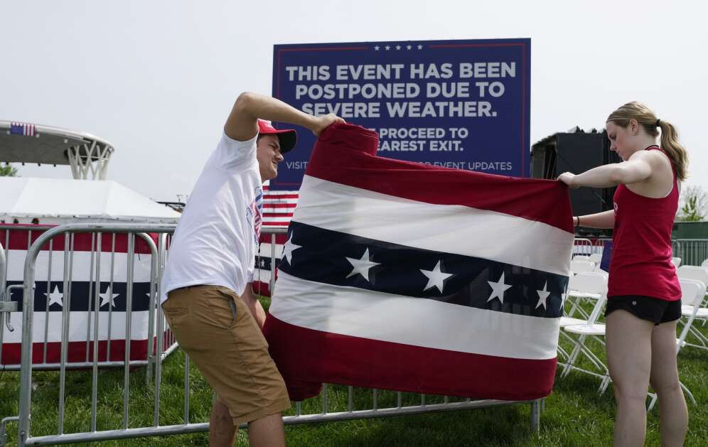 Workers take down decorations as they dismantle an event where former President Donald Trump was expected to speak at a campaign rally Saturday in Des Moines. The campaign canceled the rally due to severe weather. (AP Photo/Matthew Putney)
