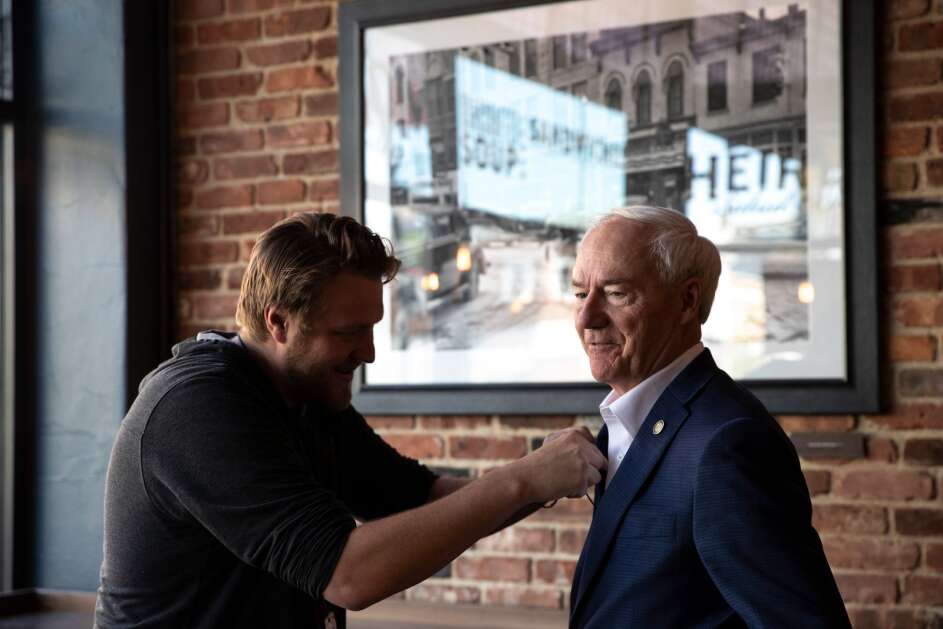 KCRG-TV9 photojournalist Nick Nading mics up 2024 GOP presidential candidate and former Arkansas Gov. Asa Hutchinson before an event held by the University of Iowa  College Republicans on Monday, May 1, 2023, at Heirloom Salad Company in Iowa City, Iowa. (Geoff Stellfox/The Gazette)