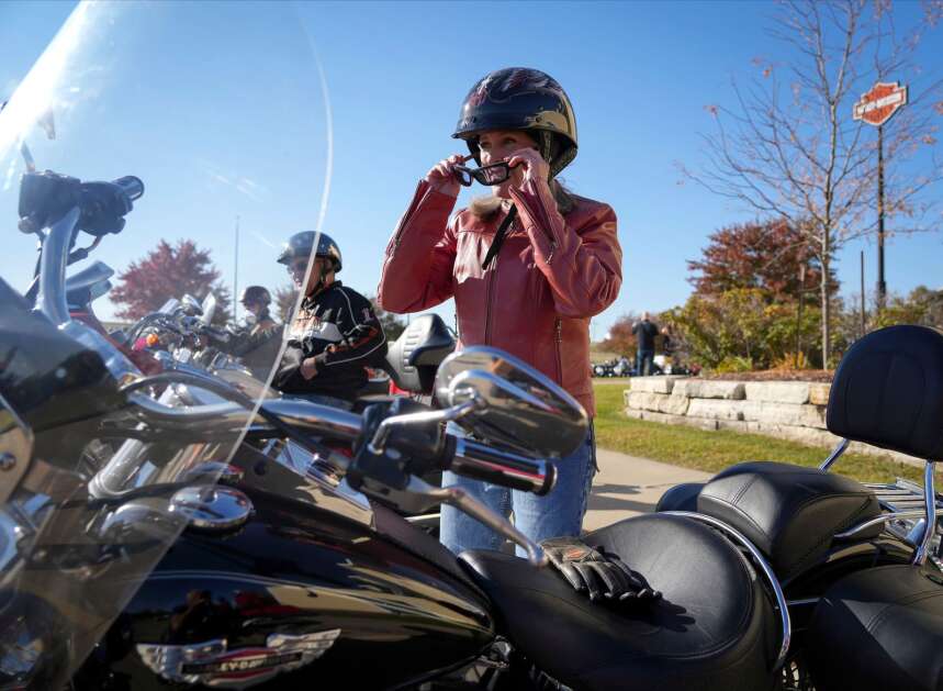 Sen. Joni Ernst, R-Iowa puts on her goggles before riding her Harley-Davidson motorcycle during her annual Roast and Ride in Des Moines, Iowa, on Saturday, Oct. 22, 2022. (Bryon Houlgrave /The Des Moines Register via AP)