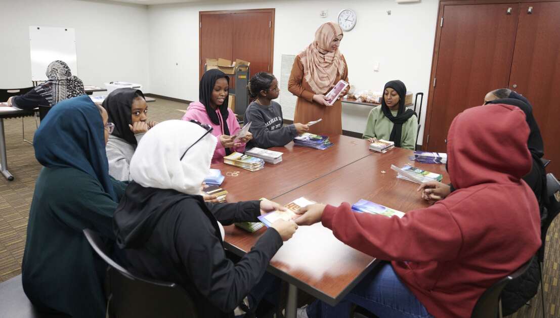 Viana Qadoura, founder and director of the Mariam Girls’ Club, instructs members on assembling packets of educational brochures on Islam for distribution at an upcoming annual World Hijab Day event at the Coralville Public Library on Saturday, January 27, 2024. The club is partnering with the library for the second year with the library to host a public World Hijab Day event on Thursday, February 1 at 4:30pm where participants can learn about the hijab and women in Islam. “We are organizing this event to bring awareness, to foster personal freedom of religious expressions, and to dismantle bigotry, discrimination, and prejudice against Muslim women and girls wearing the hijab” says  Qadoura. (Cliff Jette/Freelance)