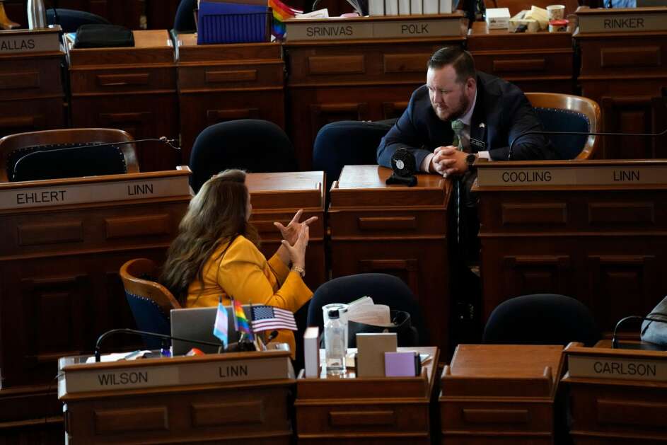 Rep. Jeff Cooling (right), D-Cedar Rapids, talks with Rep. Elizabeth Wilson, D-Marion, in the Iowa House chamber Thursday, the last day of the 2023 legislative session. Democrats said they were disappointed in most of the bills passed this session.  (Charlie Neibergall/Associated Press)