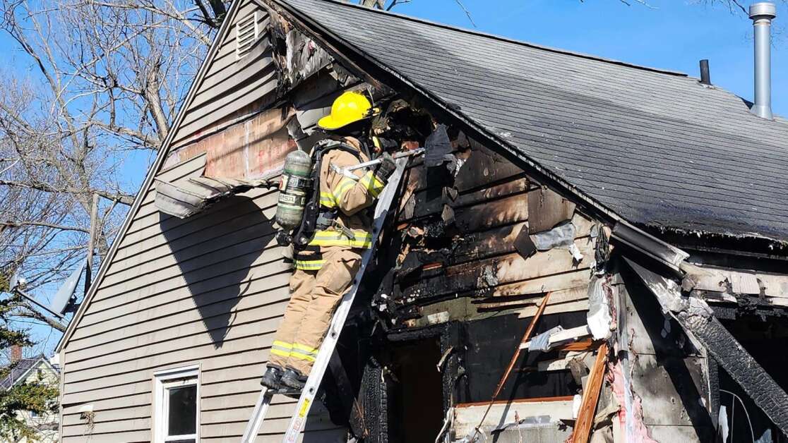 A Cedar Rapids firefighter responds to a fire that killed one man and injured another in the 1200 block of N Street SW in Cedar Rapids on Tuesday. (Cedar Rapids Fire Department)