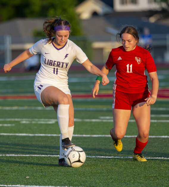 Iowa City Liberty midfielder Maya Marquardt (11) turns the ball with pressure from Marion defender Amerie Hall (11) in the second half of the game at Marion High School in Marion, Iowa on Thursday, May 25, 2023. (Savannah Blake/The Gazette)