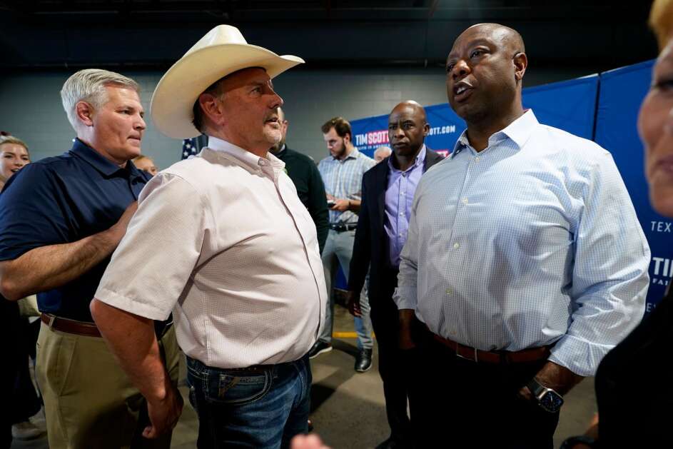 Republican U.S. Sen. Tim Scott speaks Wednesday to Clinton Vos of Lawton, Iowa, during a Wednesday town hall at a private Christian school in Sioux City. (Charlie Neibergall/Associated Press