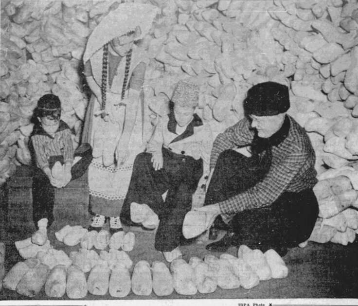 Out of 1,000 pairs of wooden shoes just received from Holland, Tony Tysseling (from left), Doris Dockendorff, Brice Heerema and P.H. Kuyper  get theirs fitted before the 1947 Tulip Time Festival in Pella. The 1946 festival, right after the end of World War II, was canceled and replaced with a community auction to raise money for war relief in Holland, (Iowa Daily Press Association)