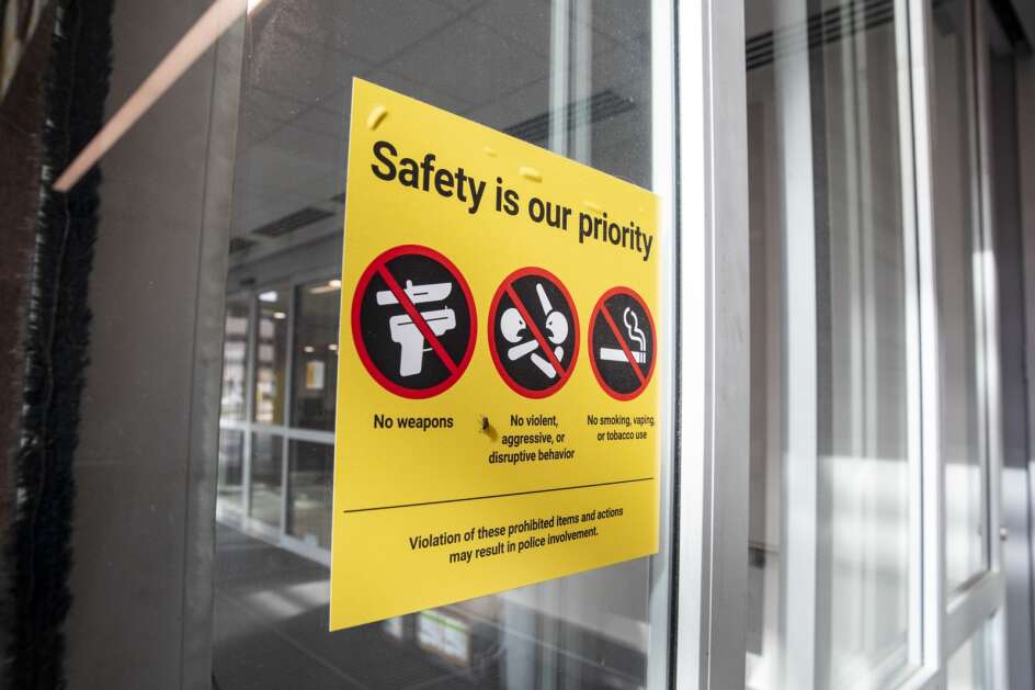 A sign prohibiting weapons and other items at the main entrance to The University of Iowa Hospital in Iowa City on Friday, April 14, 2023. A bill passed by Iowa House lawmakers would allow guns in school and college parking lots. The bill, among other provisions, allows anyone who can legally carry a firearm to keep it in their locked vehicle in the parking lots of schools, city and county buildings, state universities and prisons. (Nick Rohlman/The Gazette)