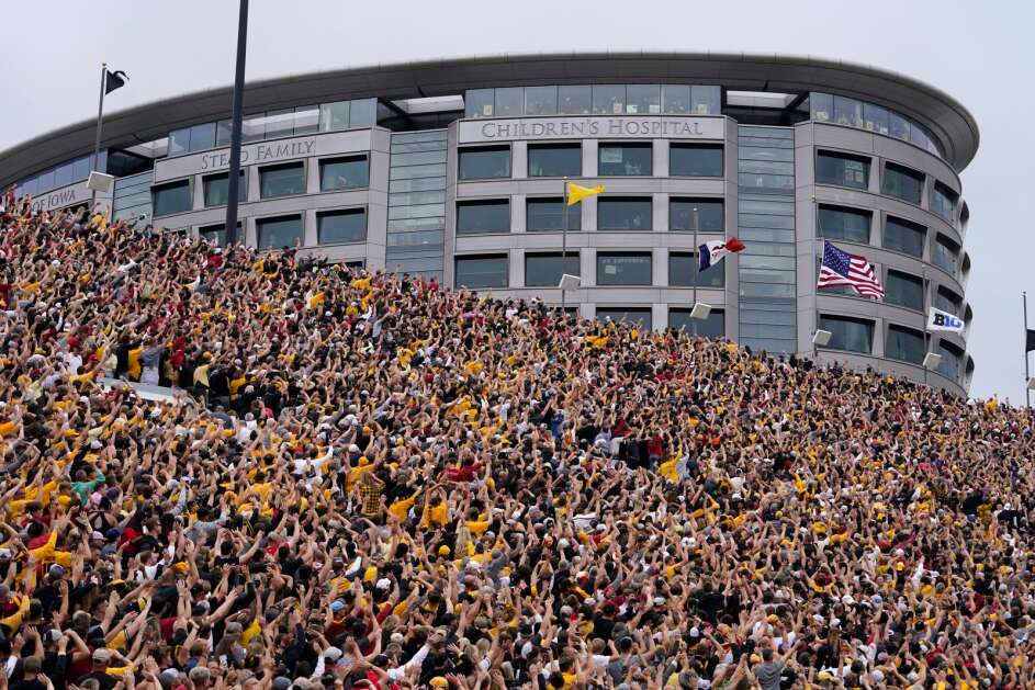 Fans wave to children in the University of Iowa Stead Family Children's Hospital at the end of the first quarter of the Sept. 10, 2022, football game between Iowa and Iowa State. A new report ranks UI Health Care as   the second “most trusted health care brand” in the country. (Associated Press) 