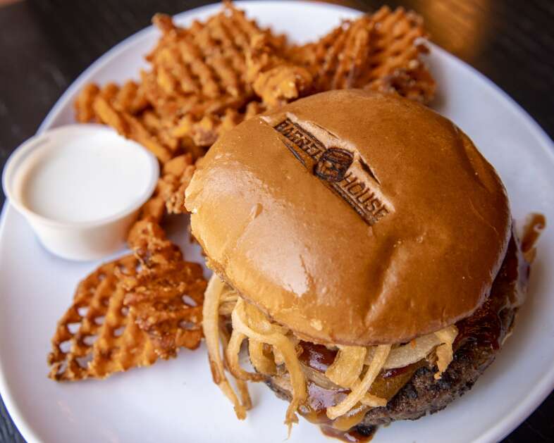 The Cowboy Burger, sweet potato waffle fries, and marshmallow dipping sauce at Barrel House’s location in Cedar Rapids, Iowa on Friday, April 28, 2023. (Nick Rohlman/The Gazette)