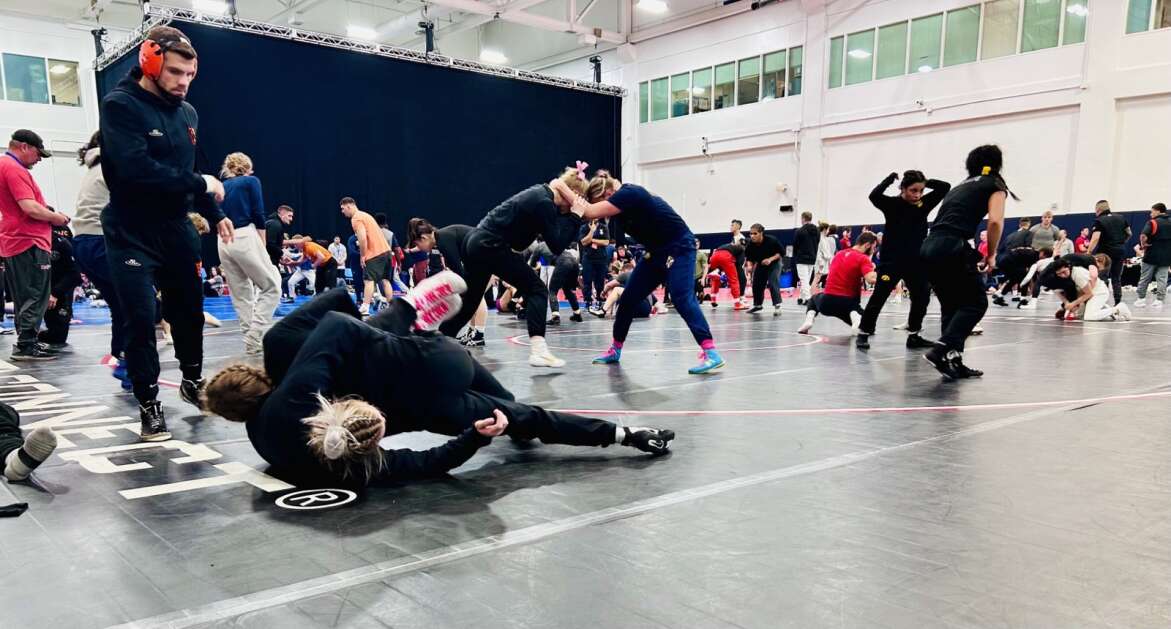 Hawkeye wrestlers Felicity Taylor and Eva Bayless warm up with other teammates before the challenge portion of the U.S. Olympic Trials on Friday, April 19, 2024 in State College, Pennsylvania.  (Vanessa Miller, The Gazette)