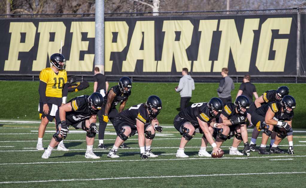 Offensive players prepare to run through a scrimmage during spring practice at the Iowa football practice field in Iowa City, Iowa on Thursday, April 11, 2024. (Savannah Blake/The Gazette)