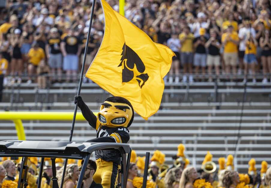 Herky hoists a Hawkeye flag on the field before the start of the game at Kinnick Stadium in Iowa City on Saturday, September 3, 2022. (Savannah Blake/The Gazette)