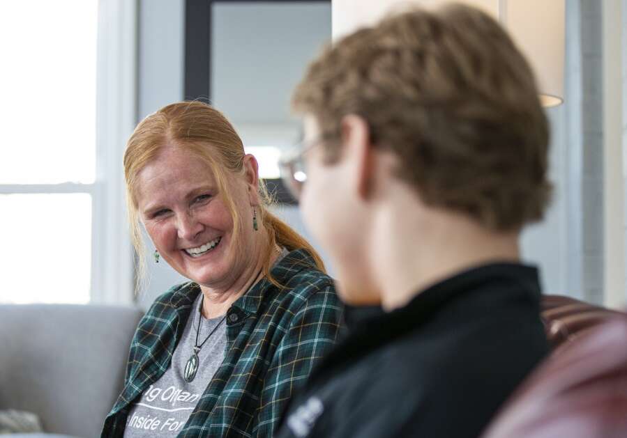 Kathi Anderson laughs with Christopher Turnis during an interview with a reporter Jan. 10 at the Ronald McDonald House in Iowa City. (Savannah Blake/The Gazette)