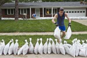 Iowa River continues to recede as volunteers remove sandbags from…