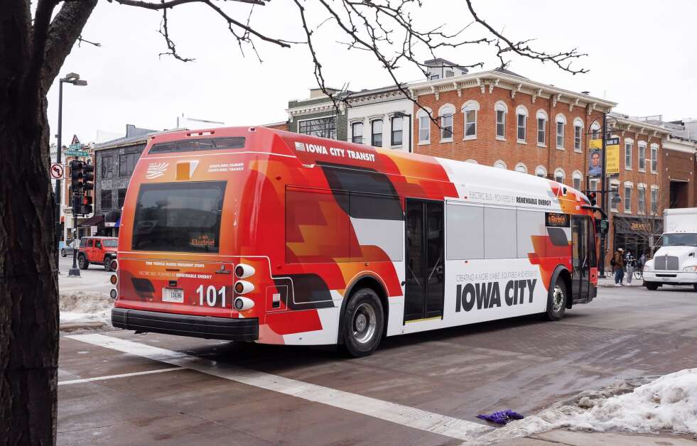 One of the electric buses in the Iowa City Transit fleet pulls away from its stop Jan. 27, 2022, outside Old Capitol Town Center in Iowa City. (Jim Slosiarek/The Gazette)