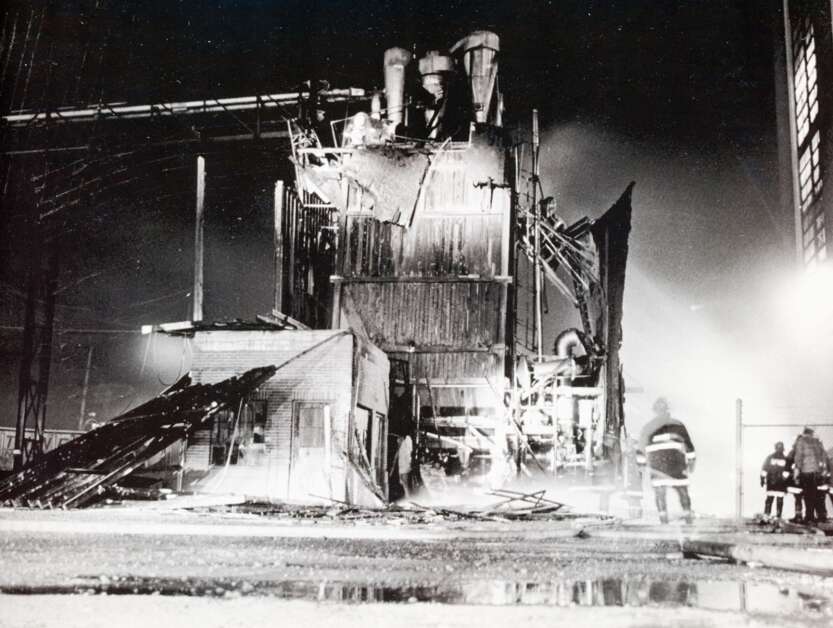 Cedar Rapids firemen watch over the Nov. 3, 1978, fire that damaged the Quaker building where furfural residue was stored. Production of the organic compound had to halt while repairs were made. (Gazette archives) 