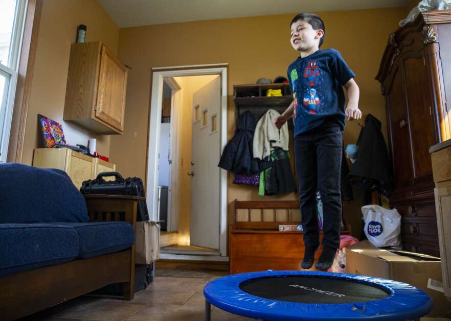Paul Rustebakke, 7, goes over his timetables while jumping on the trampoline at his home April 13 in Cedar Rapids. Paul is kinesthetic and likes to use physical activity like jumping on the trampoline or going outside to help him learn. (Savannah Blake/The Gazette)
