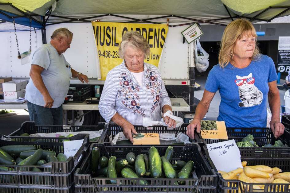 Ray Musil, Joan Musil, and Pamela Pettit (from left) work the Musil Gardens stand at the Cedar Rapids Farmers’ Market in Cedar Rapids, Iowa on Saturday, July 2, 2022. (Nick Rohlman/The Gazette)