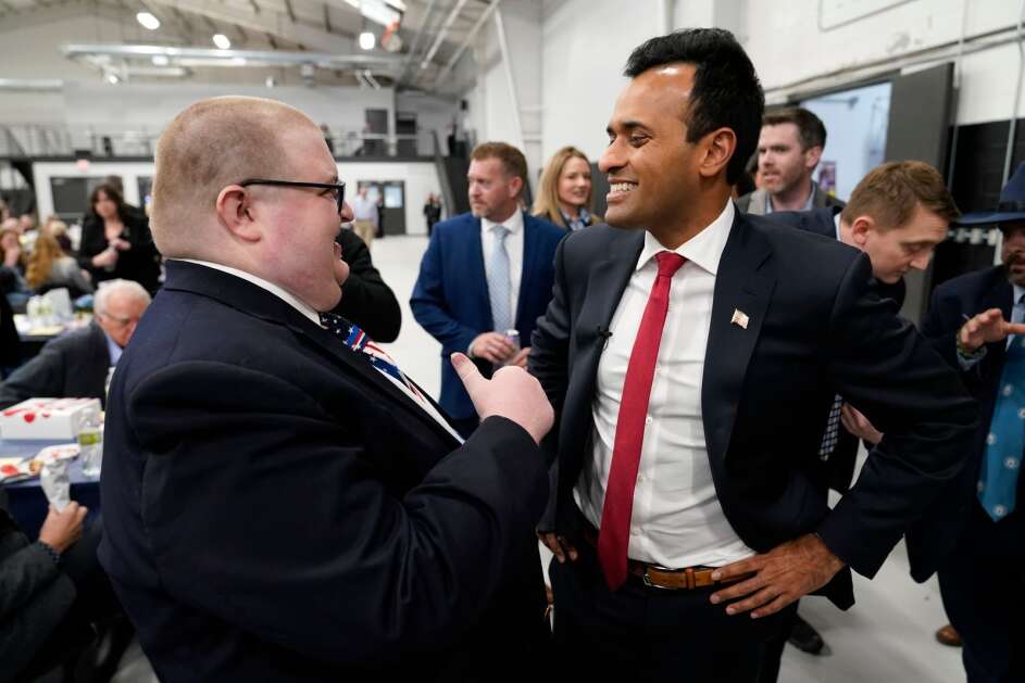 Republican presidential candidate Vivek Ramaswamy, right, talks with an audience member during the Iowa Faith and Freedom Coalition Spring Kick-Off, Saturday, April 22, 2023, in Clive, Iowa. (AP Photo/Charlie Neibergall)