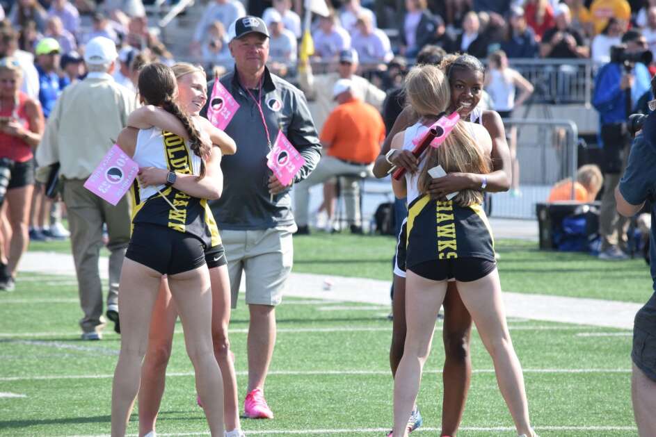 Mid-Prairie’s 4X200 of Tabitha Evans, Jovi Evans, Amara Jones and Madeline Schrader embrace after winning a Class 2A state championship on Friday, May 19, 2023, at the state track tournament in Des Moines.  (Hunter Moeller/The Union)