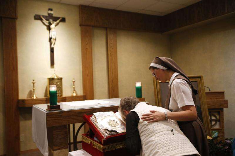 Local Catholics emotional in honoring relic from late Pope John Paul II
