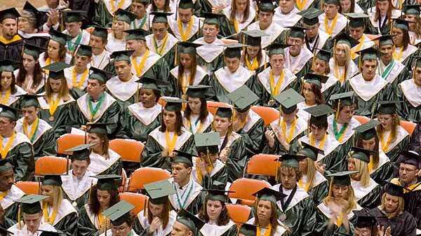 Graduates listen to the Concert Choir perform during the commencement ceremony for Kennedy High School at the US Cellular Center in Cedar Rapids in May 2008. (Cliff Jette/The Gazette)