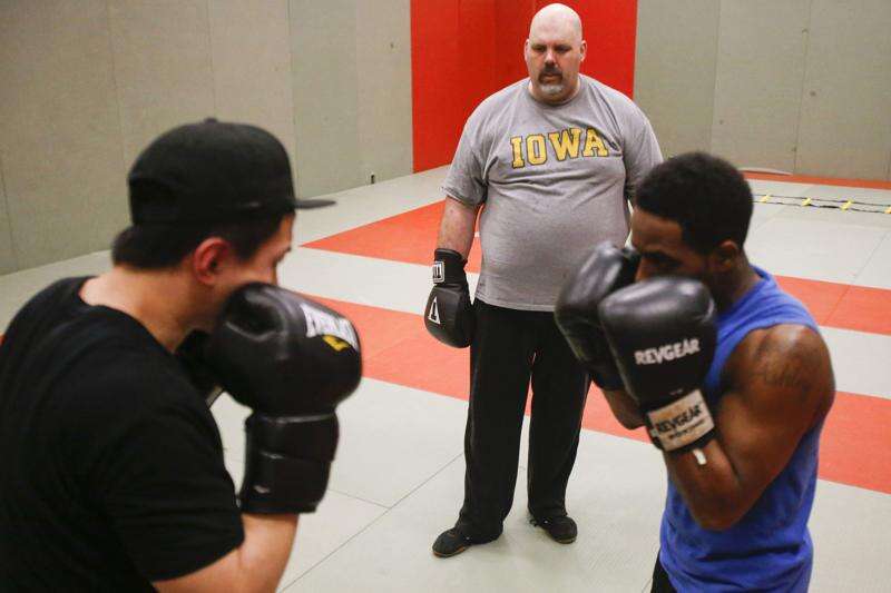 George Chamberlain watches as Hao Du and Randy Robinson, both of Iowa City, practice at the University of Iowa's Boxing Club in the Field House on Thursday, May 12, 2016. Chamberlain has been coaching amateur boxing for 20 years, and coaches out of a gym on First Street in Iowa City. Prior to his coaching career he boxed professionally for nine years. (Rebecca F. Miller/The Gazette)
