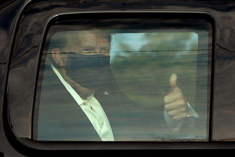 Trump, riding in motorcade, greets supporters