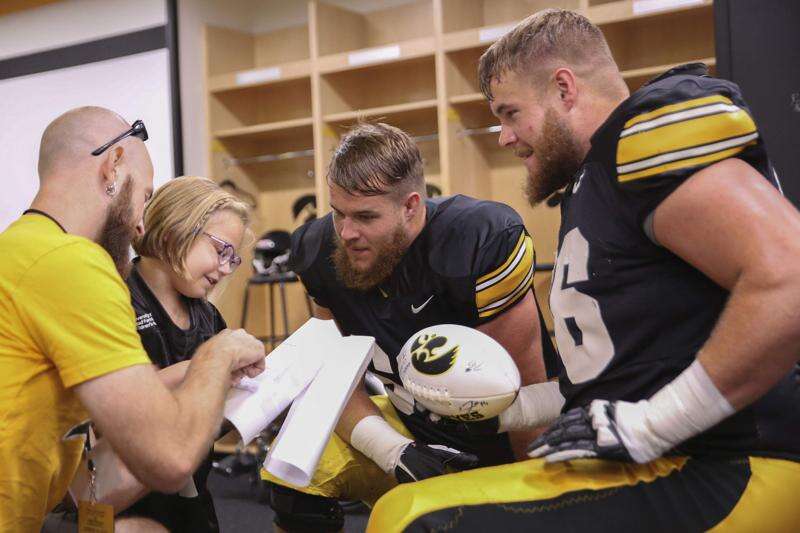 Iowa twins Levi and Landan Paulsen move couches, donate hair and guide young Hawkeyes together