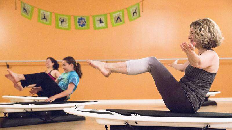 Surfboard yoga offered at Coralville’s Downward Dog studio