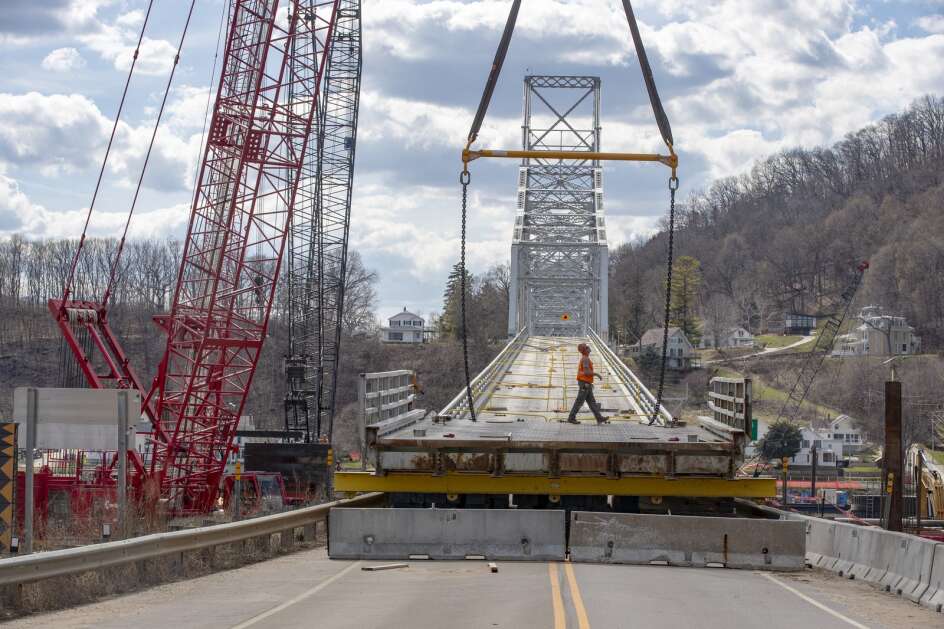 Workers prepare April 10 to place a bridge section as repairs continue on the Black Hawk Bridge in Lansing. Repairs later were completed and the bridge was reopened to traffic Saturday after an inspection. (Nick Rohlman/The Gazette)
