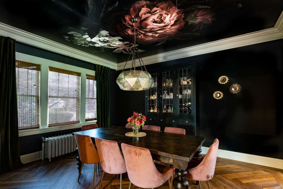A stunning wallpaper ceiling and dark walls bring a romantic and modern feel to Horn’s dining room while still incorporating historic features such as the built in which she painted black to blend with the design. (Photo Submitted)