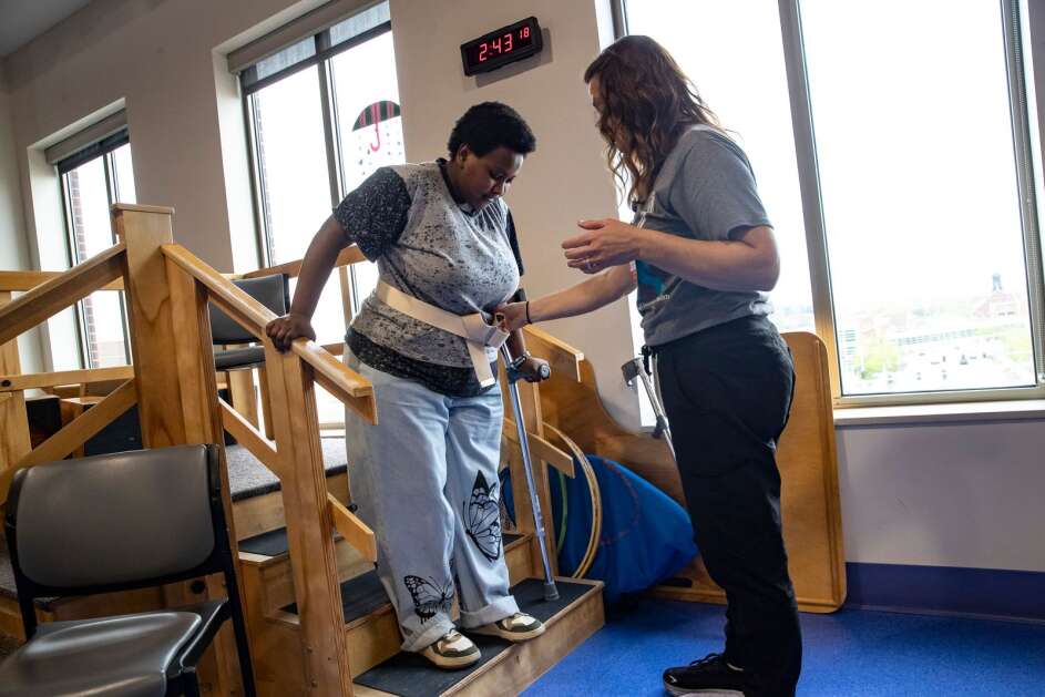 Nakiza Nyankundwa, a senior at Jefferson High School, works May 5 with therapist Jen Janatscheck to complete her exercises at UnityPoint Health-St. Luke’s Hospital in Cedar Rapids. Nyankundwa lost her right leg to a drunken driver in 2020, and now plans to walk across the graduation stage later this month during commencement. (Geoff Stellfox/The Gazette)