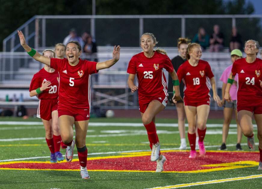 Marion forward Jade Redmond (5) celebrates with her teammates Thursday at Marion after defeating Liberty to advance to the girls’ state soccer tournament. (Savannah Blake/The Gazette)