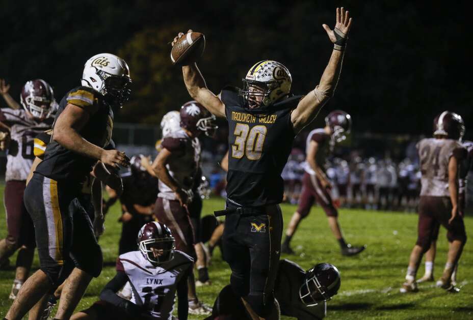 Maquoketa Valley's Lance McShane (30) celebrates the go-ahead touchdown in the fourth quarter of their Class A District 4 football game at Maquoketa Valley High School in Delhi on Friday. The Wildcats won, 22-15. (Jim Slosiarek/The Gazette)