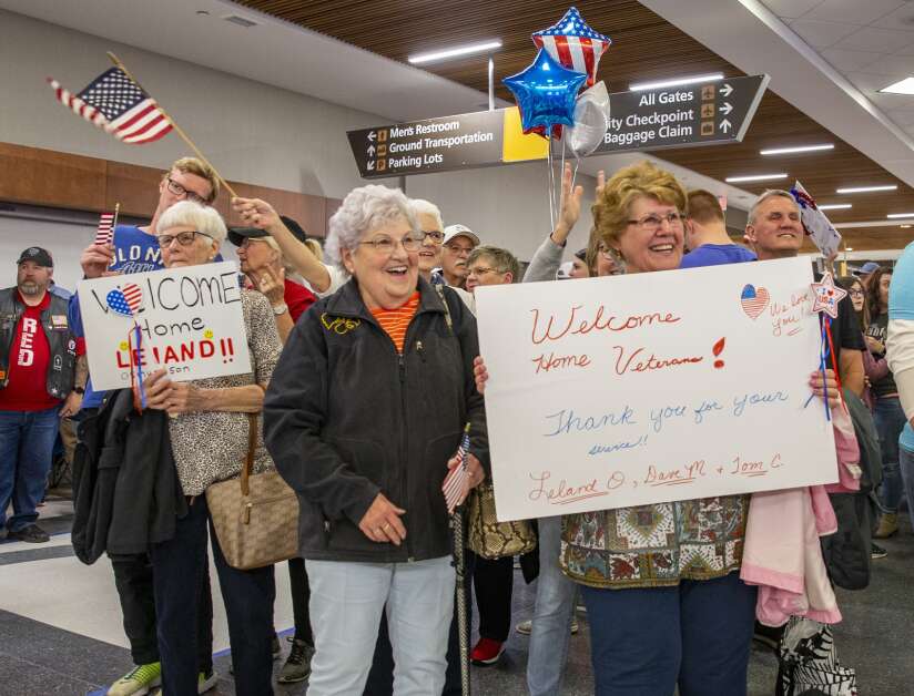 Hundreds of people gather to celebrate the return of the Honor Flight at the Eastern Iowa Airport in Cedar Rapids, Iowa on Tuesday, April 25, 2023. (Savannah Blake/The Gazette)