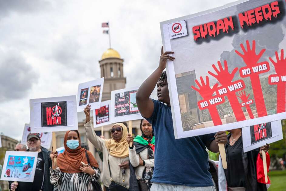 Over 50 demonstrators, including many Sudanese immigrants, attended a silent rally to bring awareness to the ongoing Sudan civil war on Saturday, April 29, 2023, at the Pentacrest in Iowa City, Iowa. (Geoff Stellfox/The Gazette)