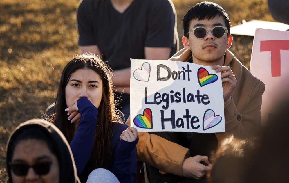Linn-Mar High School juniors Briana Clymer (left) and Dragon Zheng attend a student-led walkout at Linn-Mar High School in Marion, Iowa, on Wednesday, March 1, 2023. Students from schools across the state walked out to protect anti-LGBTQ+ legislation working its way through the Iowa Legislature. (Jim Slosiarek/The Gazette)
