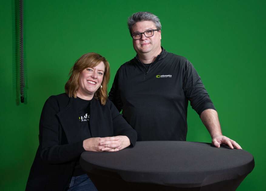 John and Stacie Osako stand in the studio of Informatics Inc. in Cedar Rapids on Tuesday. John and his father, Frank, founded the web design and digital marketing business 25 years ago. (Savannah Blake/The Gazette)