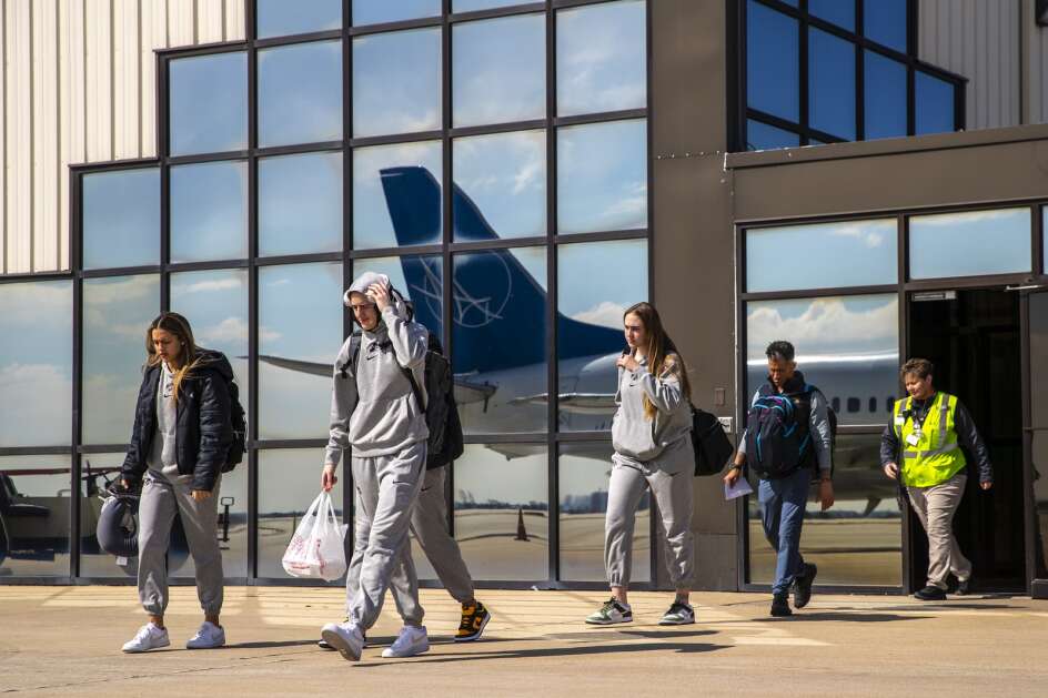 Caitlin Clark and her Iowa Hawkeyes teammates prepare to board the team plane to Albany on Thursday, March 28, 2024, at the Eastern Iowa Airport in Cedar Rapids, Iowa. The Hawkeyes are preparing to take on the University of Colorado on Saturday in the Sweet 16 of the NCAA Women’s Basketball Tournament. (Geoff Stellfox/The Gazette)