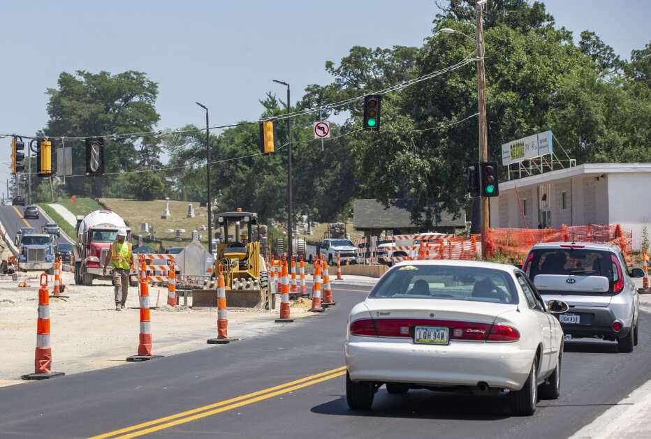 A construction worker walks to move traffic cones Wednesday on Mount Vernon Road in Cedar Rapids. The Cedar Rapids City Council this week gave the go-ahead to a new $9.9 million construction project in the area, in addition to the $7.8 million project already underway on Mount Vernon Road SE. (Savannah Blake/The Gazette)