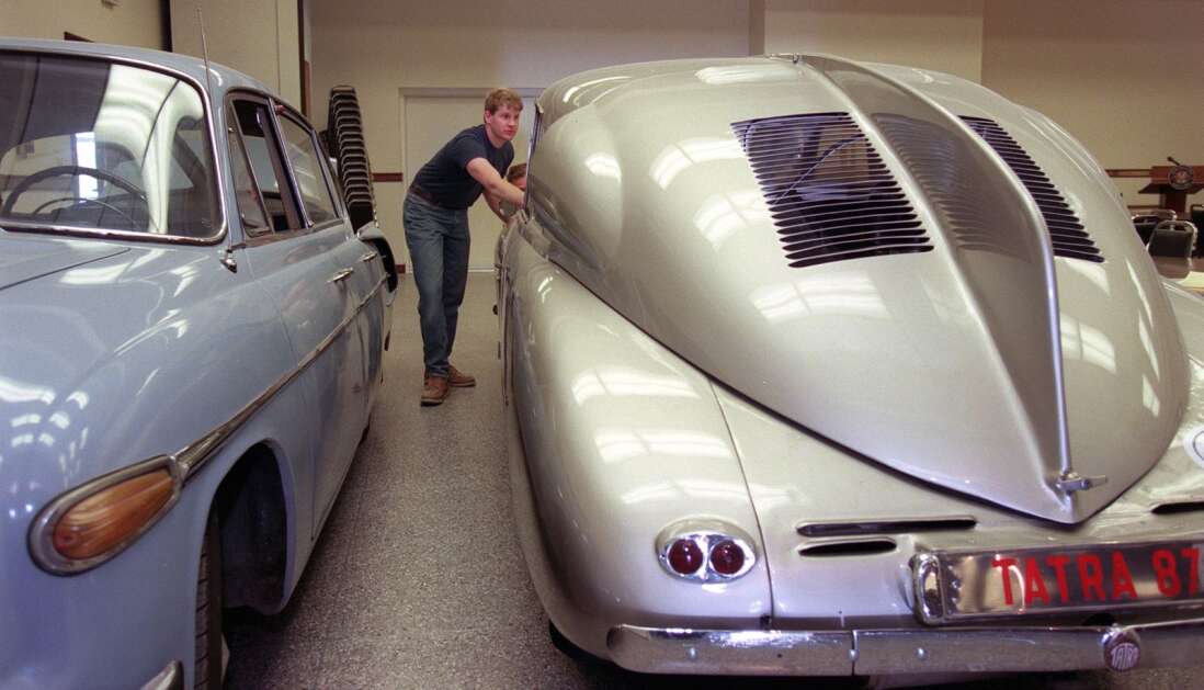 Aaron Tjaden, of Tjaden Enterprises, helps push a 1948 Tatra T 87 in the National Czech & Slovak Museum & Library in 2000. The Tatra is part of a “Czech Technology in Motion” exhibit, along with the 1963 Tatra T 603 auto on the left. Automobile manufacturing and innovation are vital industries in the Czech and Slovak republics, with the Slovaks currently researching and developing a flying car. (The Gazette)