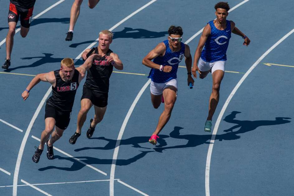 Lisbon’s Tiernan Boots hands off to Baylor Speidel (5) and Columbus Community’s Triston Miller hands off to Kaden Amigon (4) in Saturday’s Class 1A boys’ state track and field 400-meter relay at Drake Stadium in Des Moines. (Nick Rohlman/The Gazette)