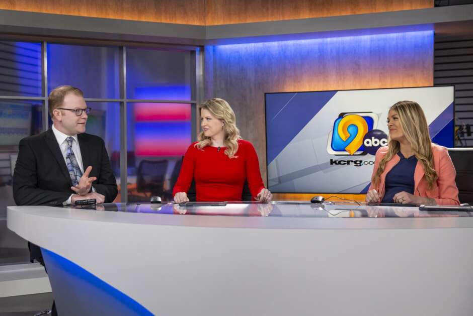 Meteorologist Kaj O’Mara chats with news anchors Jackie Kennon, left, and Kristin Rogers after delivering the forecast during the 4:30 a.m. show at the KCRG studio in Cedar Rapids on Wednesday. (Savannah Blake/The Gazette)