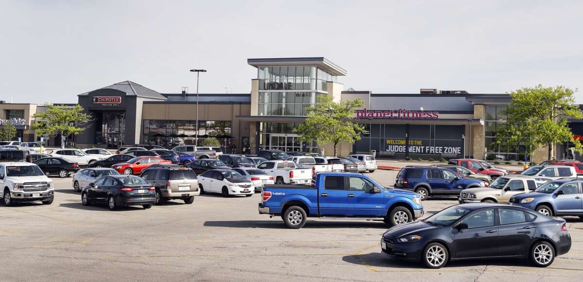 Vehicles park Tuesday outside Lindale Mall and First Avenue and Collins Road NE in Cedar Rapids. The mall was recently sold to the Kohan Retail Investment Group of Great Neck, N.Y., for $28.5 million. Kohan also bought nine other parcels around the mall, including the former Collins Road Hy-Vee. (Jim Slosiarek/The Gazette)