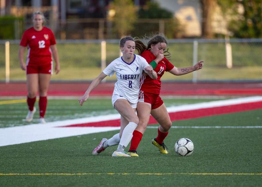Iowa City Liberty midfielder Callie Stanley (8) and Marion defender Amerie Hall (11) battle for possession of the ball in the second half of the game at Marion High School in Marion, Iowa on Thursday, May 25, 2023. (Savannah Blake/The Gazette)