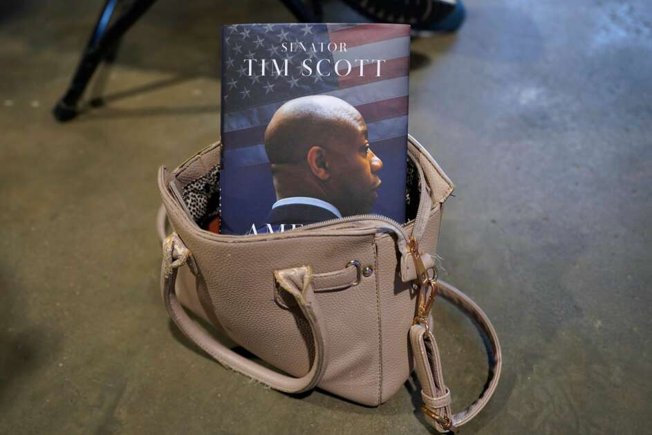 A copy of Republican presidential candidate South Carolina Sen. Tim Scott's book sits in a purse Wednesday during his campaign stop at a Christian private school in Sioux City. (Charlie Neibergall/Associated Press) 