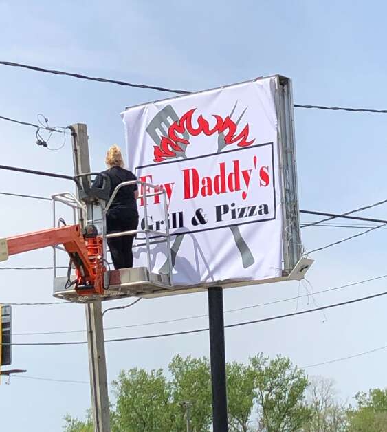 A new sign for Fry Daddy’s Grill & Pizza is seen while being installed on Wednesday, May 10, 2023 at 1500 20th St. SW in Cedar Rapids. (Jim Slosiarek/The Gazette)