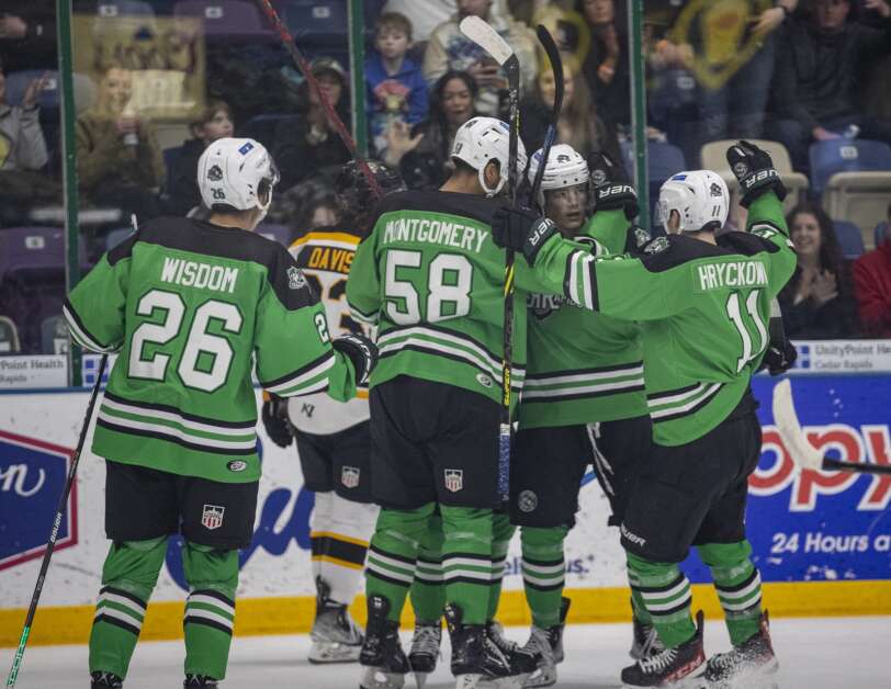RoughRiders players gather around forward Ryan Walsh after he scored a goal for the team in the first period of the game to tie with the Gamblers at ImOn Ice Arena in Cedar Rapids, Iowa on Sunday, February 5, 2023. (Savannah Blake/The Gazette)