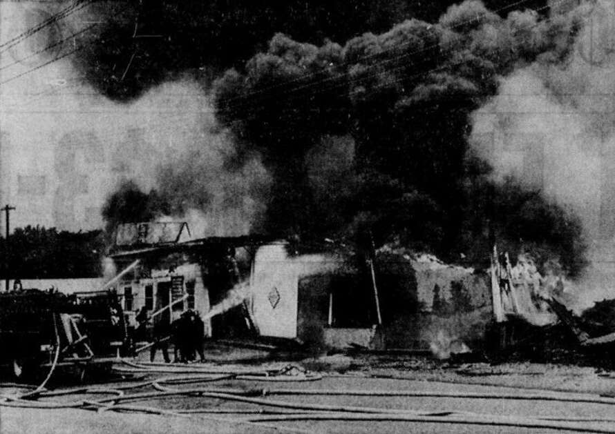 Firefighters battle the May 22, 1964, blaze at the Cedar Rapids Transfer & Storage Co. warehouse on Ninth Street SW as the building’s roof and front wall cave in. Fire Chief Jesse Hunter said the entire building was doomed by the time fire crews arrived. (Gazette archives)