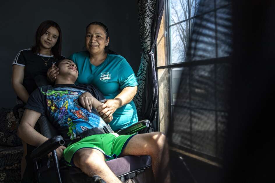 Maria Davila Hererra poses for a portrait April 12 with her son, Christian Davila Reconco, 20, and daughter, Darling, 12, at their home in Iowa City. The three fled Honduras, crossed the southern border and ended up in Iowa City. (Geoff Stellfox/The Gazette)